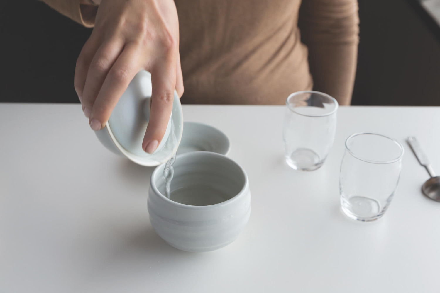 Close-up of discarding warm water from rinse