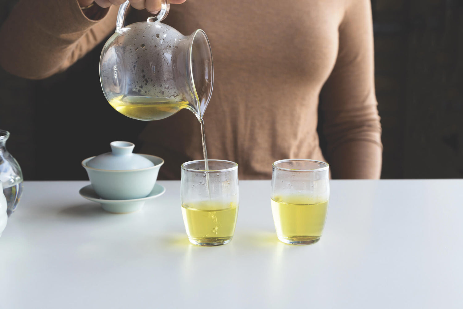 Pouring tea showing how to use and enjoy a Gaiwan tea set