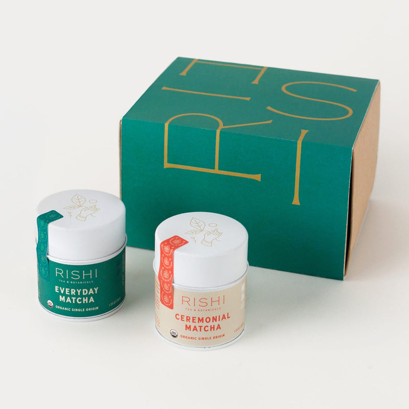 Two tins labeled “Everyday Matcha” and “Ceremonial Matcha” are placed next to a green and brown Rishi-branded box on a white surface.
