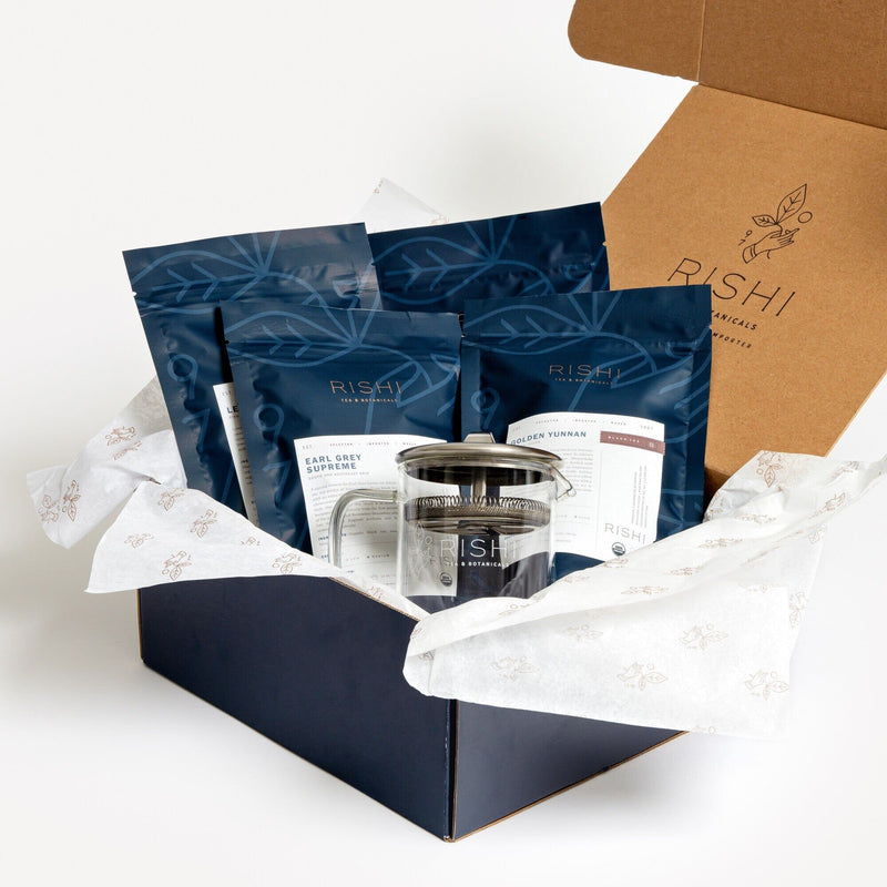 The Black Tea Gift Set, featuring black teas and loose leaf tea, is shown in front of a box.