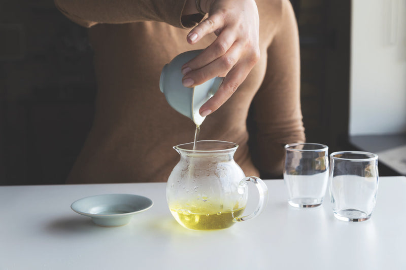 Pouring freshly prepared tea into a decanter
