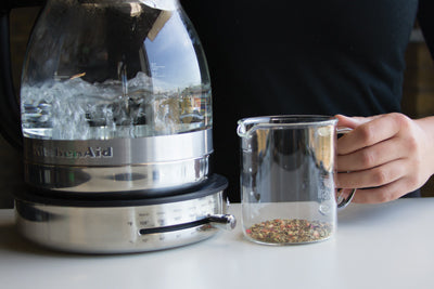 How to brew loose leaf tea requires attention to the hot water, as shown in close up 