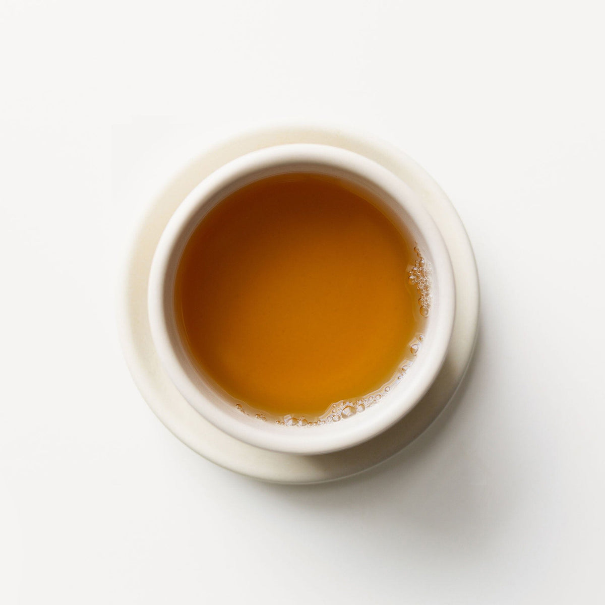 A cup of Cinnamon Tulsi Spice tea on a white background, from Rishi Tea & Botanicals brand.