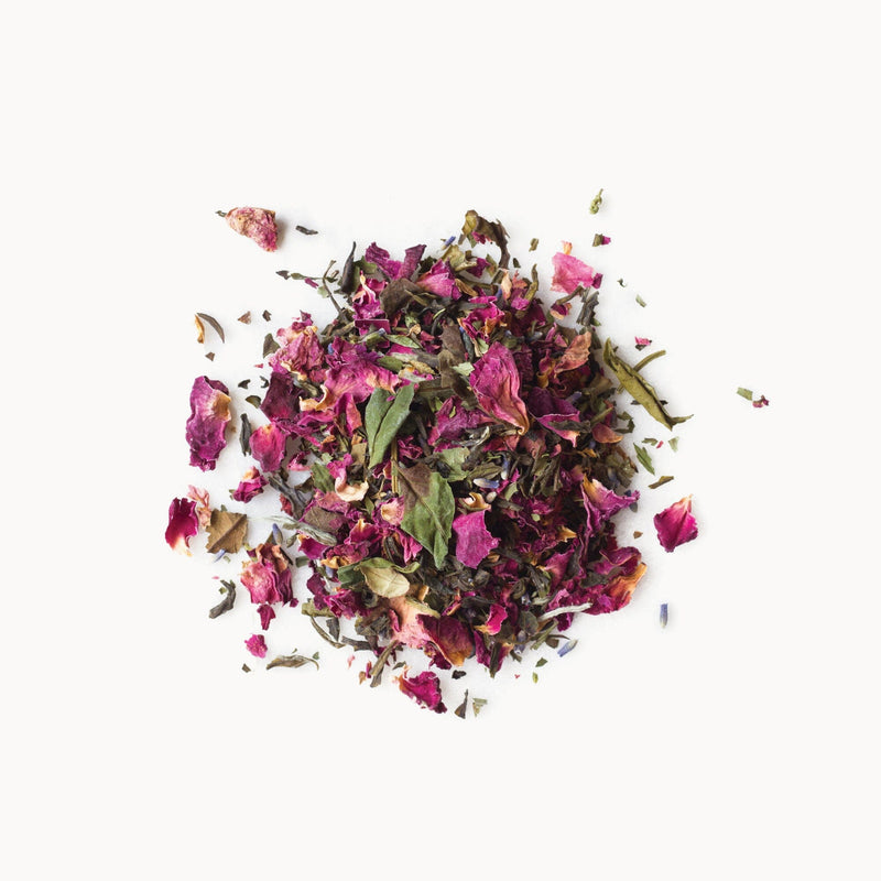 A pile of White Tea Rose Melange petals on a white background by Rishi Tea & Botanicals.