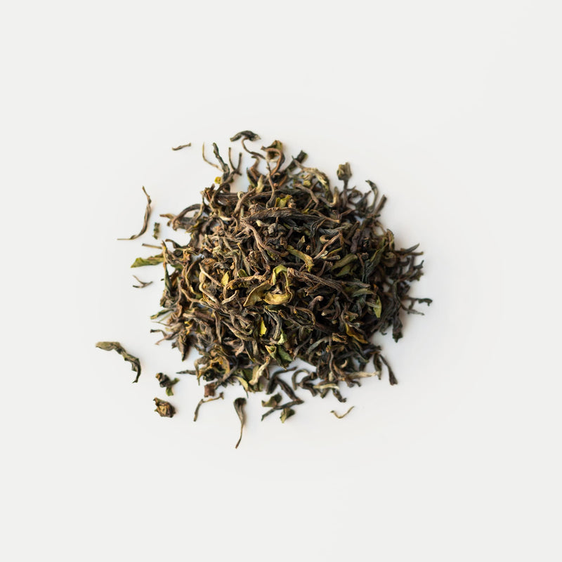 A pile of Darjeeling First Flush Lingia DJ4 from the Rishi Tea & Botanicals estate rests against a plain white background.