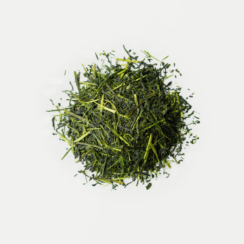 A pile of Rishi Tea & Botanicals loose-leaf organic tea with a delicate floral aroma sits on a plain white background.