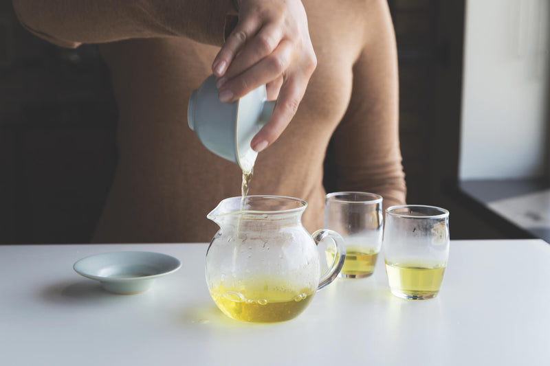 Closeup of adding each infusion to the decanter