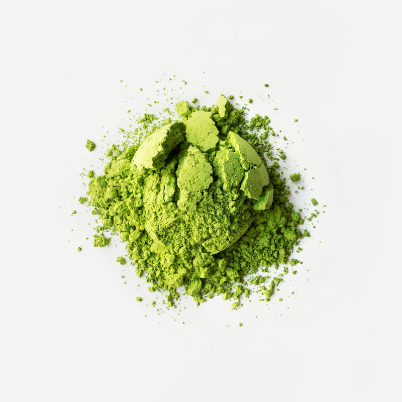 A pile of Nish-san's Matcha Tsuyuhikari green tea powder on a white background