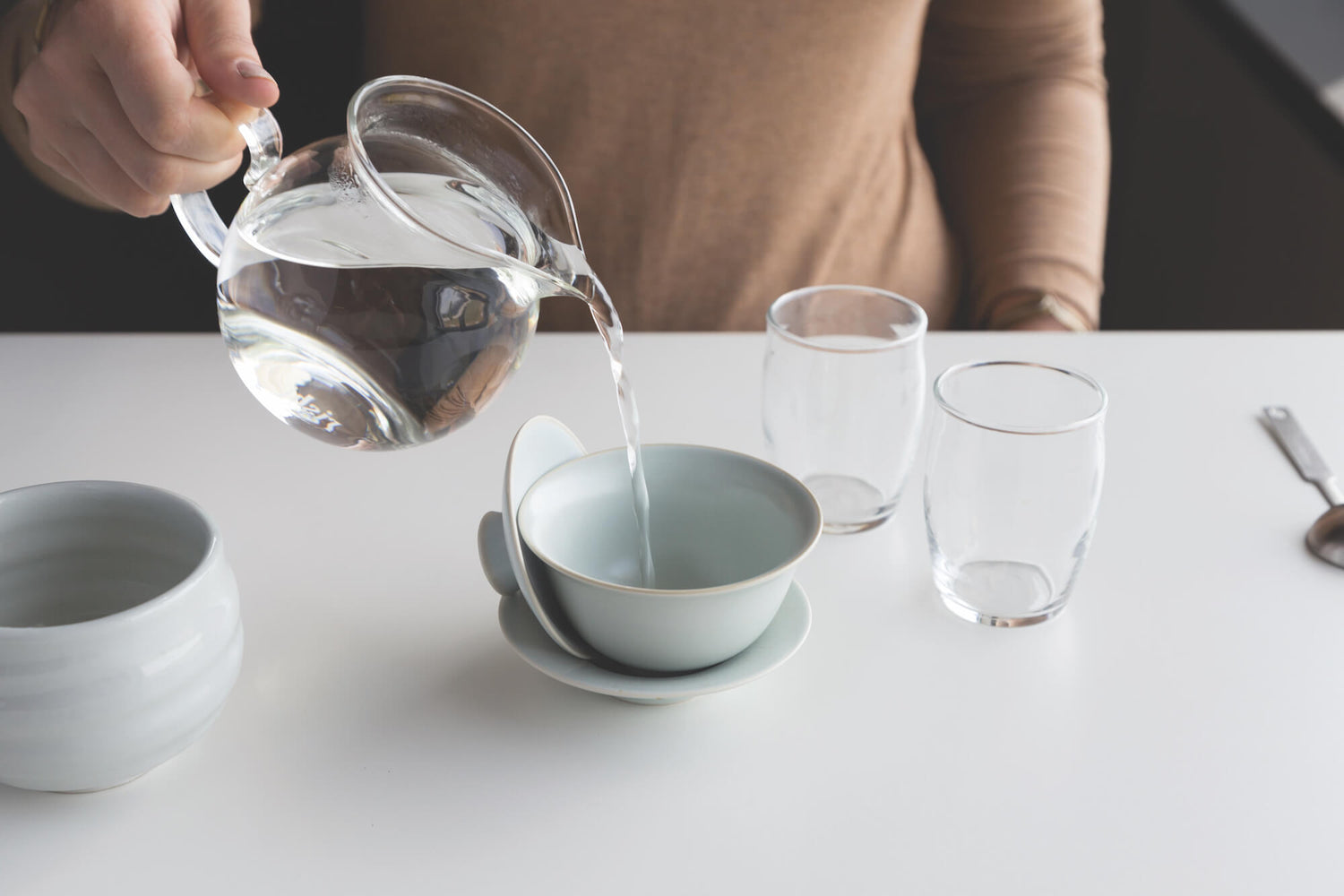 Warming a Gaiwan with warm water, the first step for this traditional Chinese tea brewing method