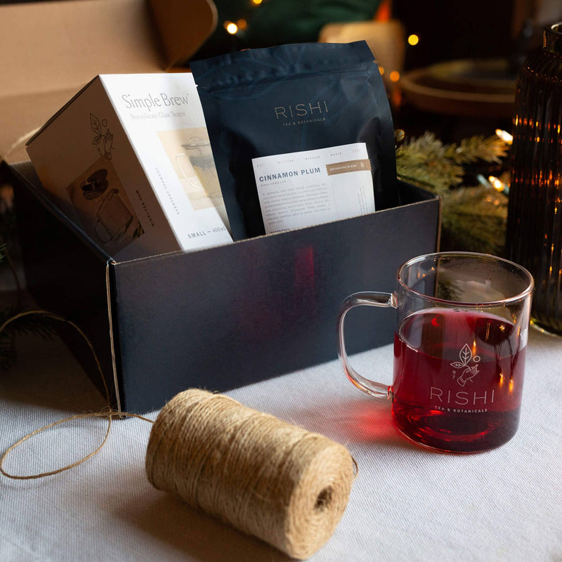 Rishi loose leaf tea of the month subscription box with spool of twine and glass mug of tea